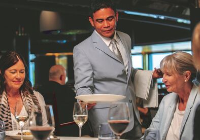 Aurora Restaurant on Borealis waiter serving guests